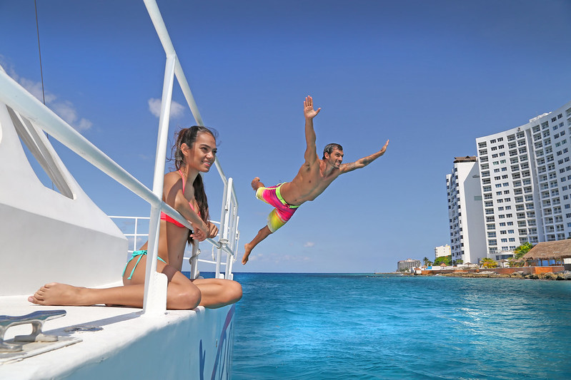 young couple enjoying Comzumel in a Yatch