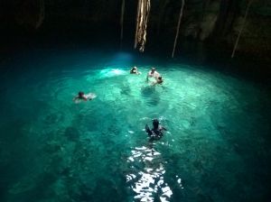 People swiming in undeground cenote