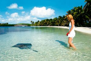 young women and ray in isla contoy mexico